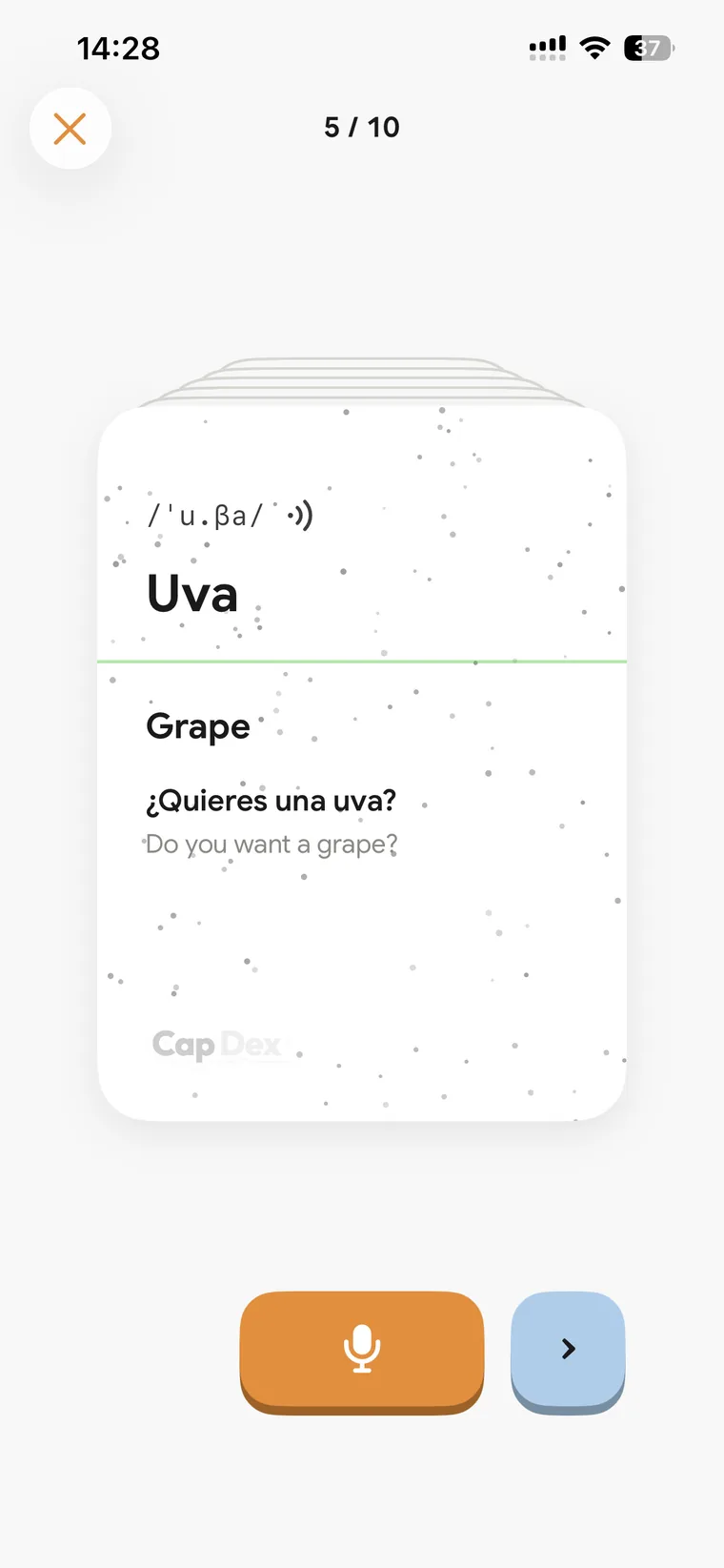 The same card turned over: Uva, its pronunciation, “Grape”, and the sentence “¿Quieres una uva?” with its translation.