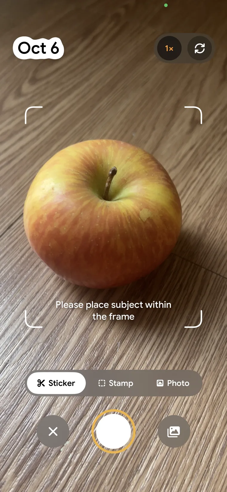 The CapDex camera in Sticker mode: an apple framed by corner brackets, with Sticker selected.